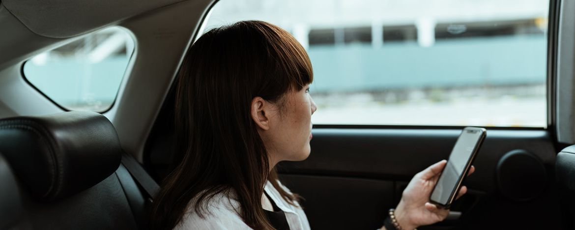 Person in car with mobile phone